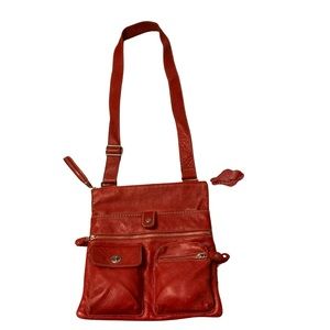 Roots leather villager tribe crossbody bag in Red.